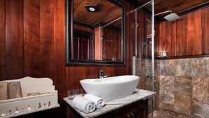 A bathroom with a large mirror, a white sink, and a shower. - Garden Bay Classic  (Bai Chay)
