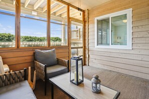 A cozy seating area with a cushioned bench, a table, and a lantern.