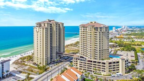 A high-rise hotel with multiple floors, a parking garage, and a beach view. - PET FRIENDLY! PENTHOUSE! 4/3 SLEEPS 11! BCH SRVC INCL!!! (Panama City Beach)