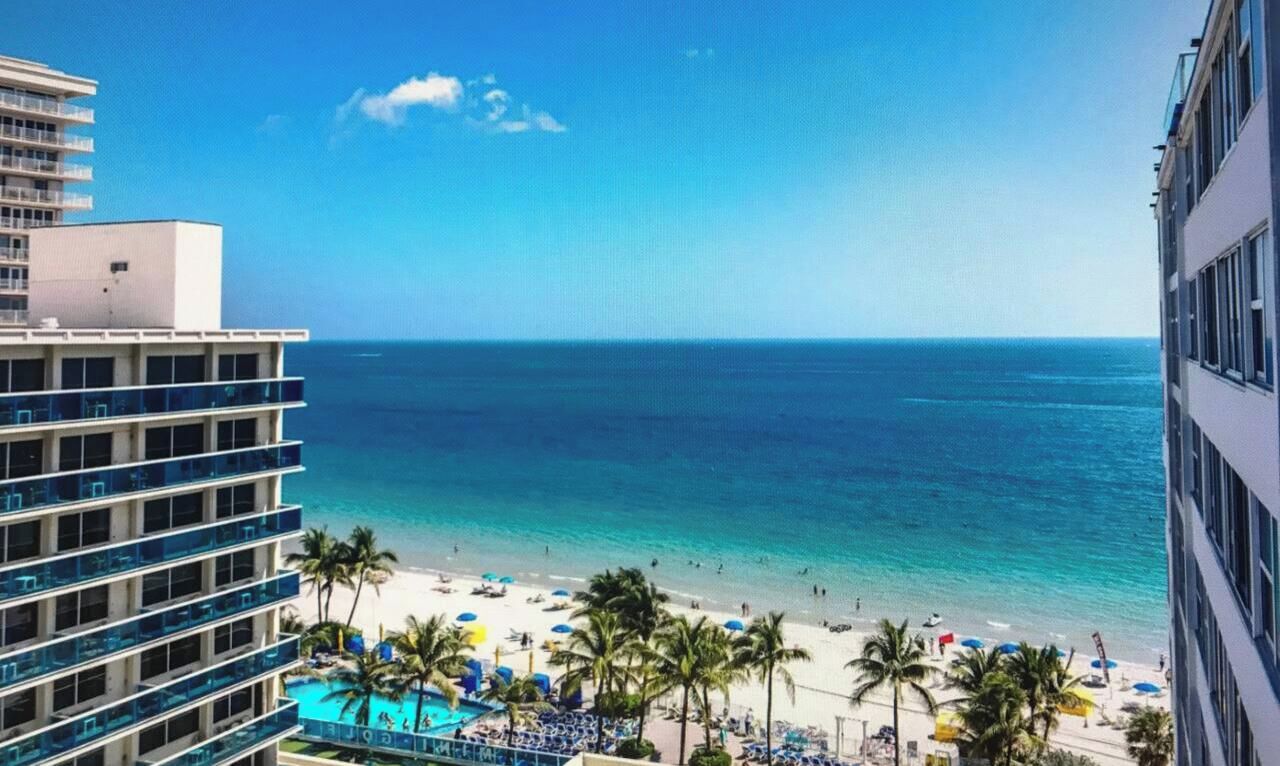 A hotel with a view of a beach and ocean.