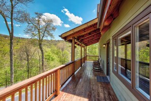 A wooden deck with a railing, overlooking a forested area. - Sugar Rush (Banner Elk)
