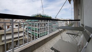 A balcony with a view of a building with multiple floors and a green roof. - Alemar in Kalithea With 1 Bedrooms and 1 Bathrooms (Kallithea)