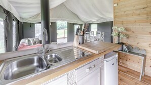 A compact kitchen with a sink, stove, and wooden counter. - Safari Tent Two - UK44405 (Ross-on-Wye)