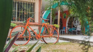 A bicycle parked in front of a building with a window and a door. - Casa Samay Cozumel (Cozumel)