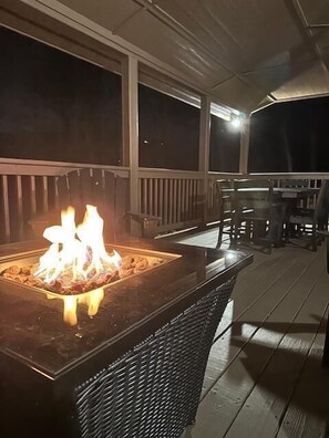 A covered outdoor area with a fire feature and outdoor furniture. - Buck Ridge (West Jefferson)