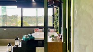A modern bathroom with a large window, wooden ceiling, and a wooden vanity with a sink. - Maison France (Campos do Jordão)