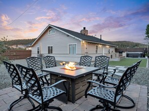 Relax by the fire pit surrounded by comfortable seating.