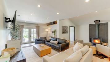 Cozy up by the fireplace and enjoy the view from the large window.