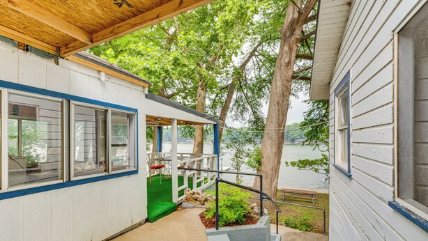A covered outdoor area with a concrete path leading to a staircase. - Lakefront Cottage in Clear Springs w/ Deck & Patio (New Braunfels)