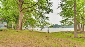 A park with trees, a picnic table, and a view of a body of water. - Lakefront Cottage in Clear Springs w/ Deck & Patio (New Braunfels)
