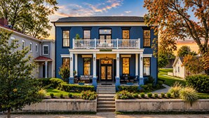 A two-story building with a balcony, a front porch, and a well-maintained garden. - 8 Bed 6 Bath Waterfront Views Bourbon Trail w/Firepit HotTub Dome Luxe Amenities (Jeffersonville)