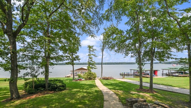 A lakeside property with a gazebo, dock, and a stone fire pit. - On the lake, sleeps 8 with dock and boat lift (Deatsville)