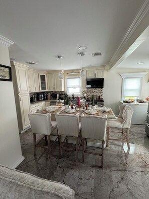 Enjoy cooking in this well-equipped kitchen with a central island, oven, microwave, and range hood.