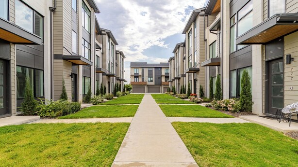 A row of modern apartment buildings with a central pathway. - Southside Retreat with Coffee Bar & Garage (Chattanooga)