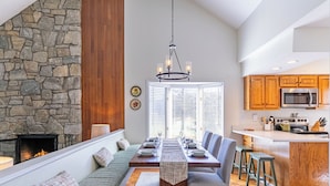 A modern kitchen with wooden cabinets, a built-in oven, and a microwave. - Chetola: Chestnut 8 (Blowing Rock)