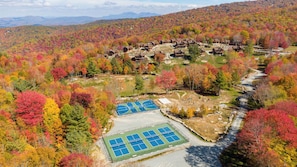 A residential area with multiple houses, a tennis court, and a river. - High Boulder Hill at Eagles Nest (Banner Elk)