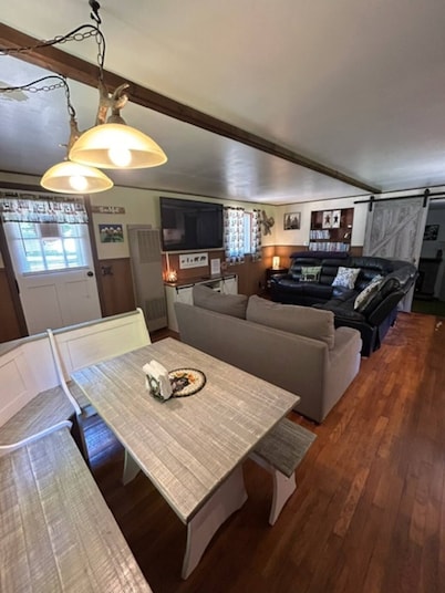 Camp Bear Bottom is a lovingly kept 1950s cabin where families gather to unplug and reconnect. Step inside to find an inviting indoor fireplace, fast Wi-Fi, and a fully equipped kitchen ready for your favorite recipes.