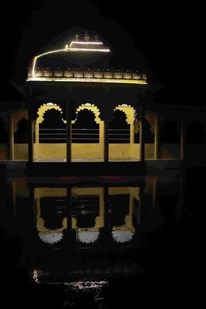 A building with a reflective water surface in front. - JK Sea Palace (Shrivardhan)