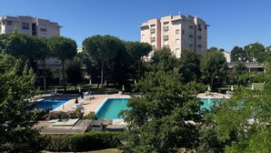 A residential building with a swimming pool, surrounded by trees and greenery. - M398 - Marcelli, three-room apartment with terrace in residence with pool (Marcelli)