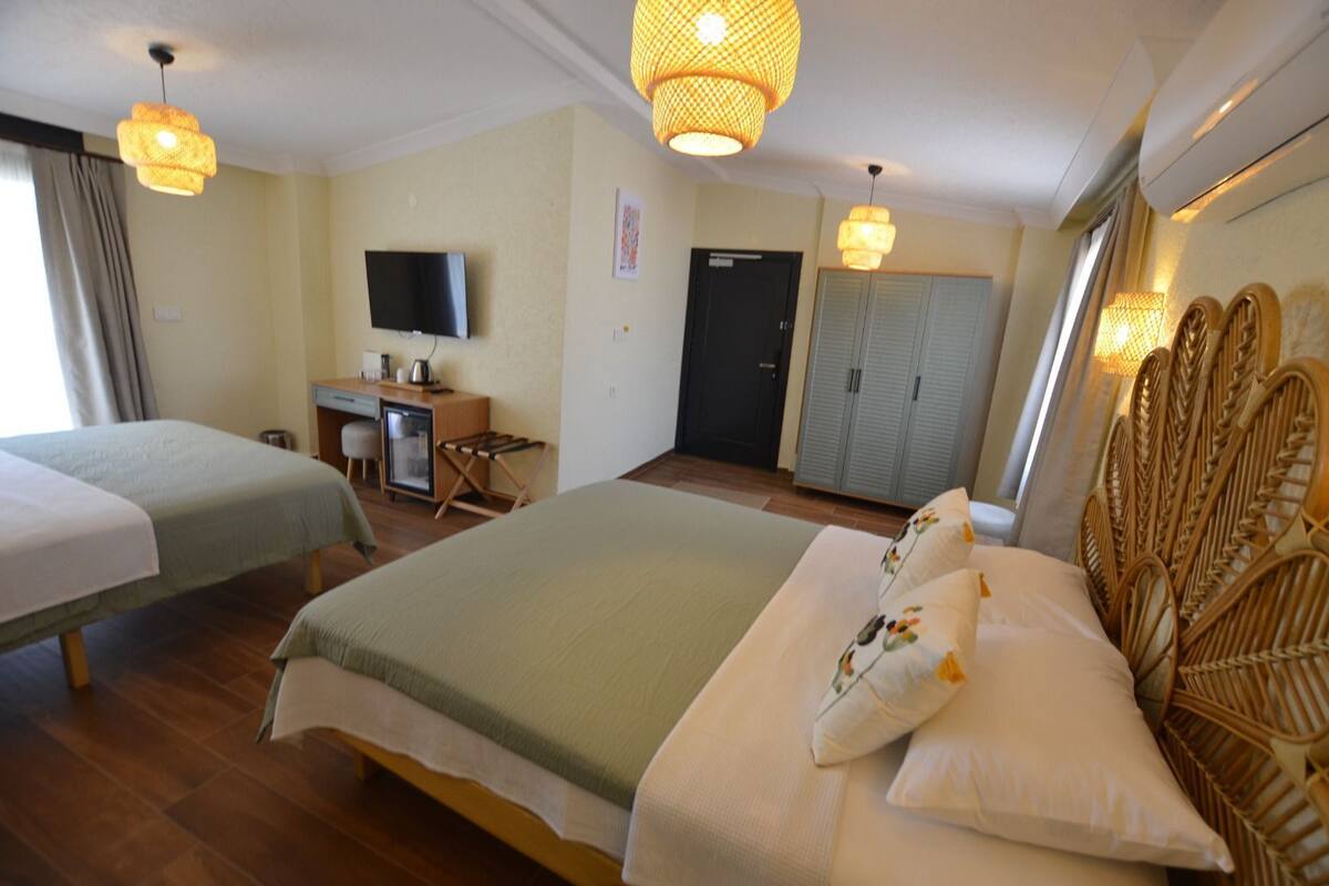 Elite Quadruple Room | Premium bedding, in-room safe, desk, laptop workspace
