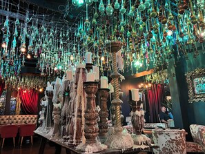 A restaurant with hanging glassware and candle-like structures, red curtains, and a tufted leather booth. - Hiking nearby, Pool and HotTub steps away, Stargazing deck, 2 King Beds! (Tubac)