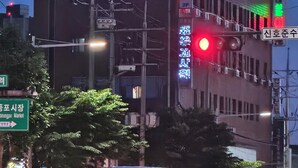 A building with a large digital billboard displaying text and a brain illustration. - Daesungjang (Seoul)