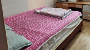 A small bedroom with a single bed, a desk, a mirror, and an air conditioning unit. - Daesungjang (Seoul)