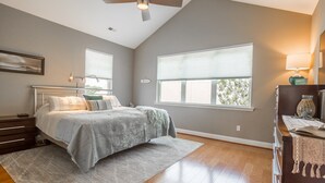 A bedroom with a bed, a nightstand, a dresser, a ceiling fan, and large windows. - Rehoboth Beach Condo w/ Pool Tennis Parking Sleeps 6 (Rehoboth Beach)