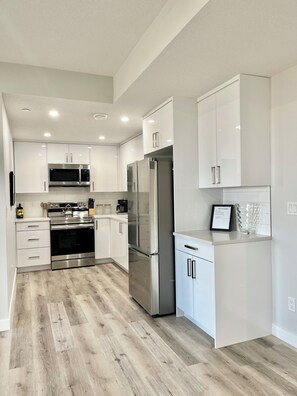 Fridge, microwave, oven, stovetop - Livingston Gem: 5BR Home with Chef's Kitchen (Calgary)