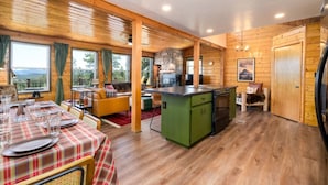 A cozy cabin-style interior with a dining area, kitchen, and seating space. - Breathtaking Views. Elevated Comfort. Pets Welcome (Prescott)
