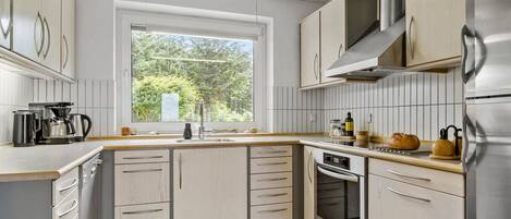 Fridge, stovetop, dishwasher, coffee/tea maker