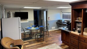 A compact kitchen with a refrigerator, microwave, and wooden cabinets. - Modern 2 Bed Suite on Bourbon Trail (Loretto)