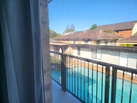 Outdoor pool. Top View Deluxe Self-Contained Room No 3 with Balcony Overlooking Swimming Pool.