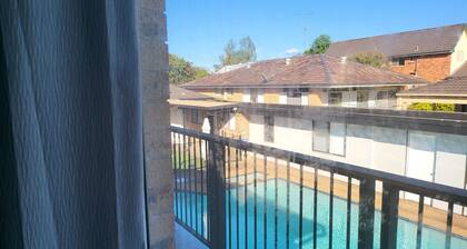 Top View Deluxe Self-Contained Room No 3 with Balcony Overlooking Swimming Pool.