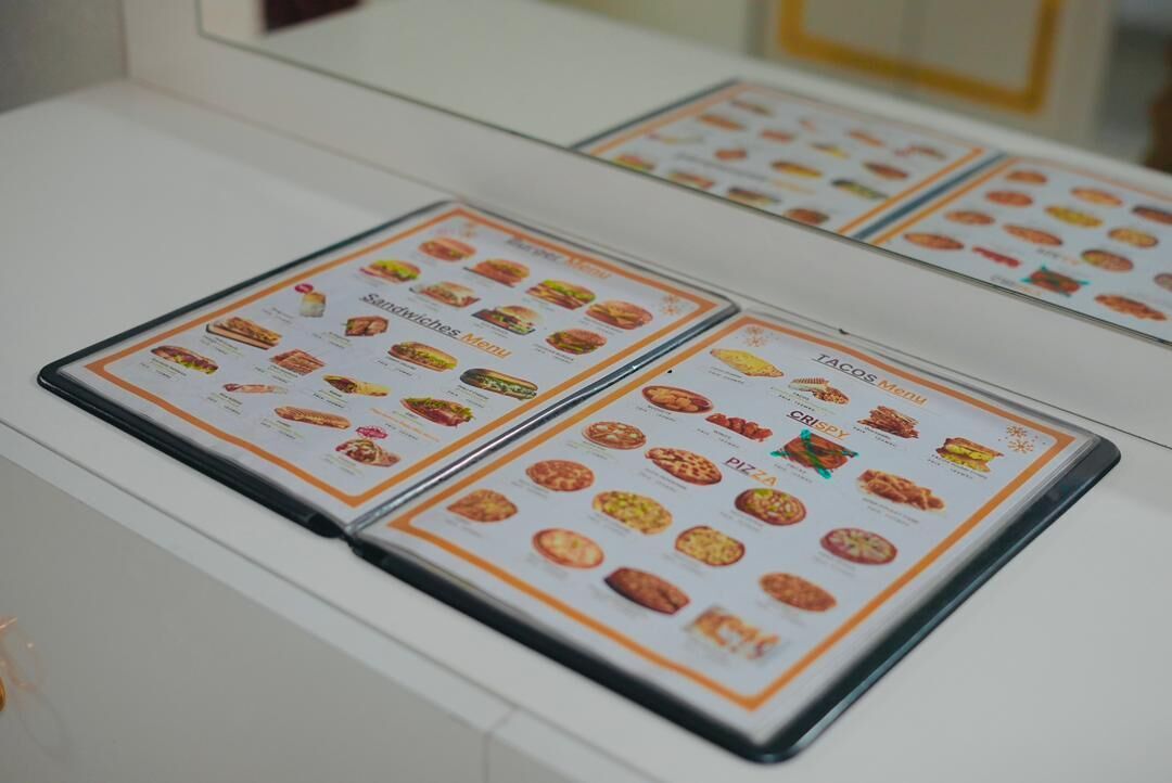 A menu board with various food items displayed.