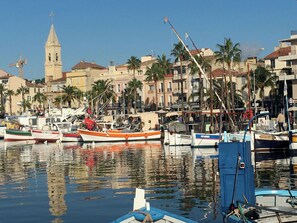 Stunning marina views with boats docked and historic buildings in the background.
