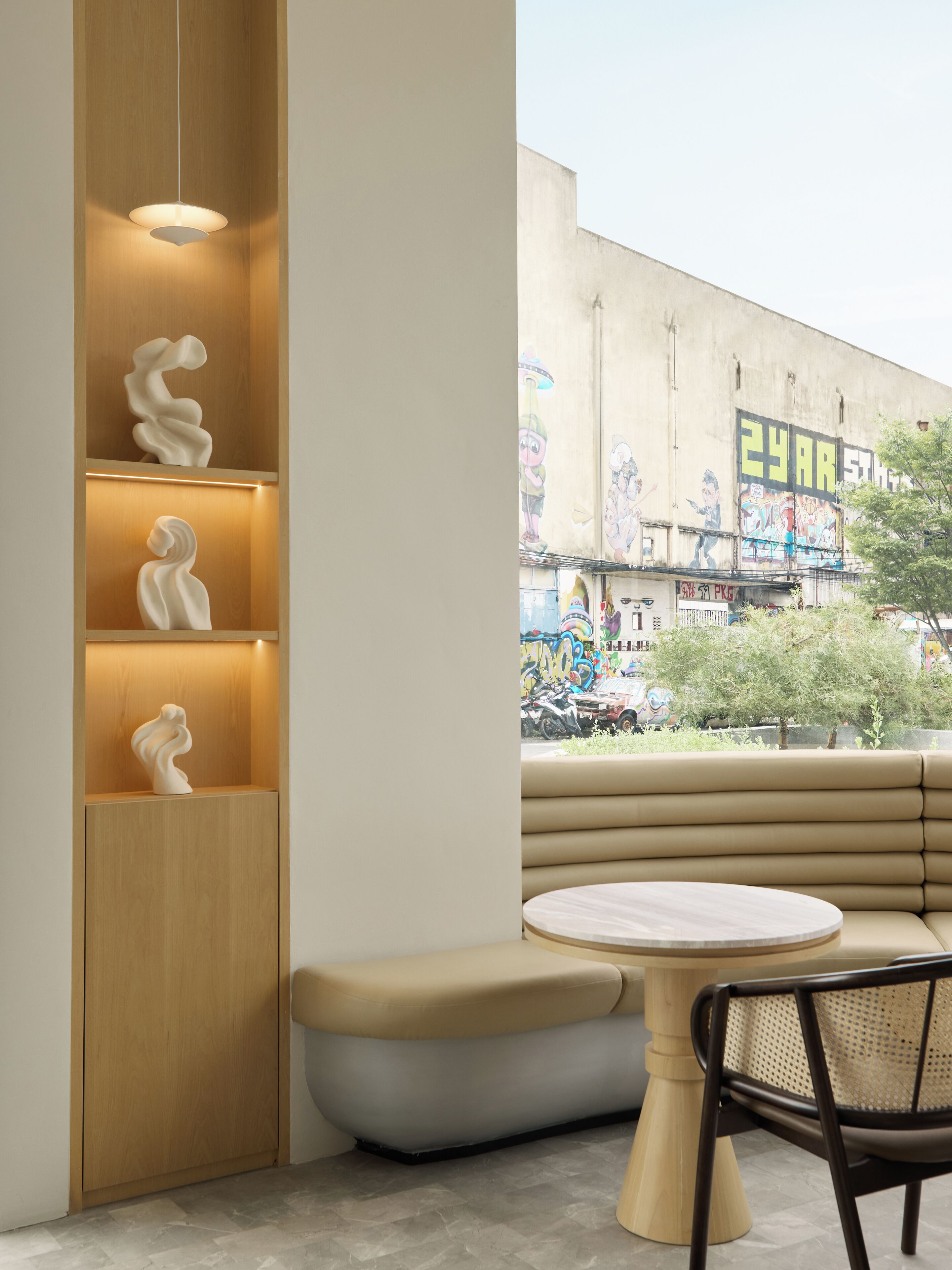 A modern interior with a wooden accent wall, a bench, and a table.