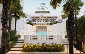 A modern hotel with a pool, palm trees, and a grand opening sign for 2024. - Arco Phuket Town (Phuket)