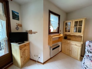Cozy retreat with a bed, TV, and ample storage.