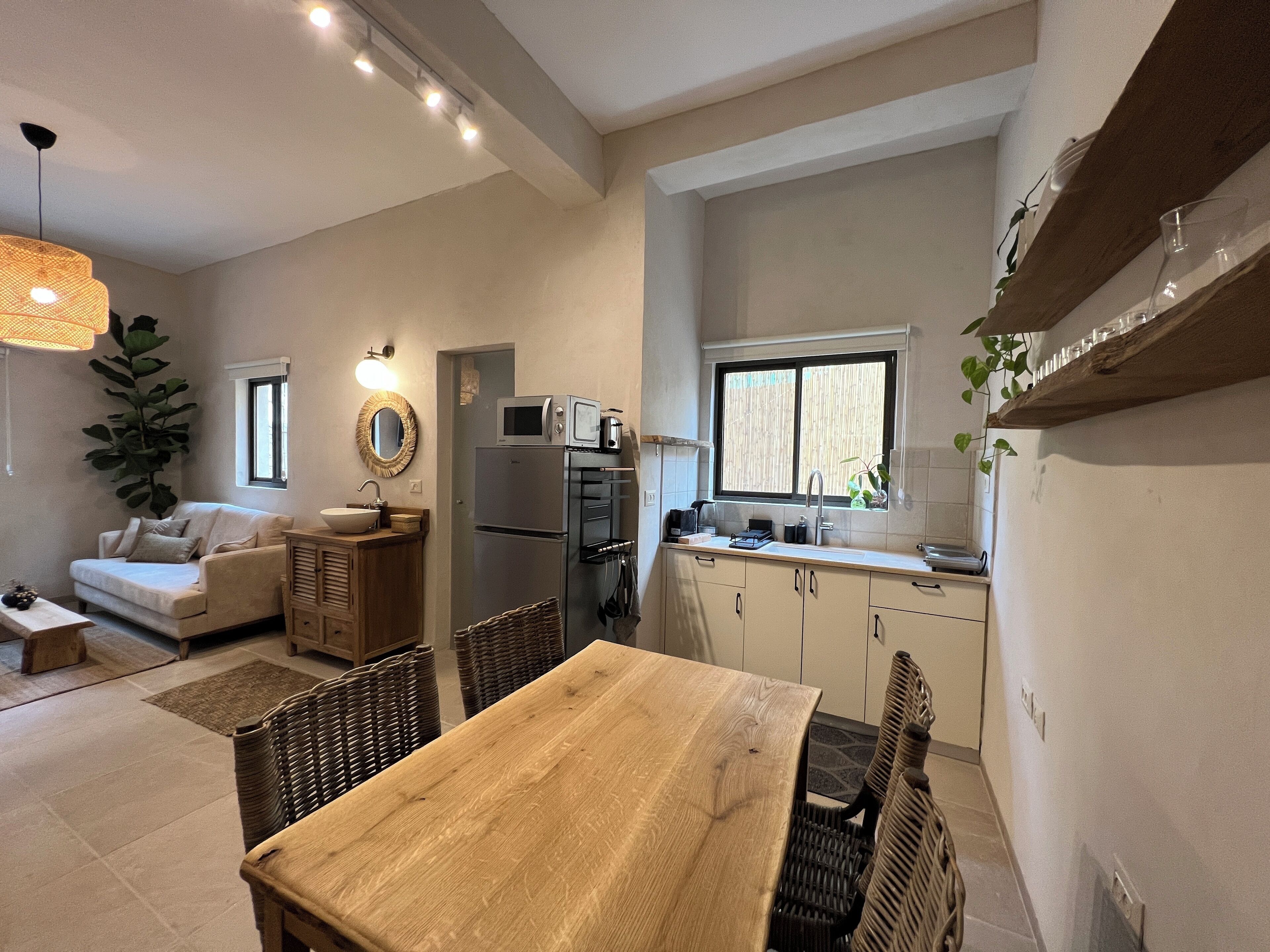 A compact living space with a kitchenette, a dining area, and a seating area.