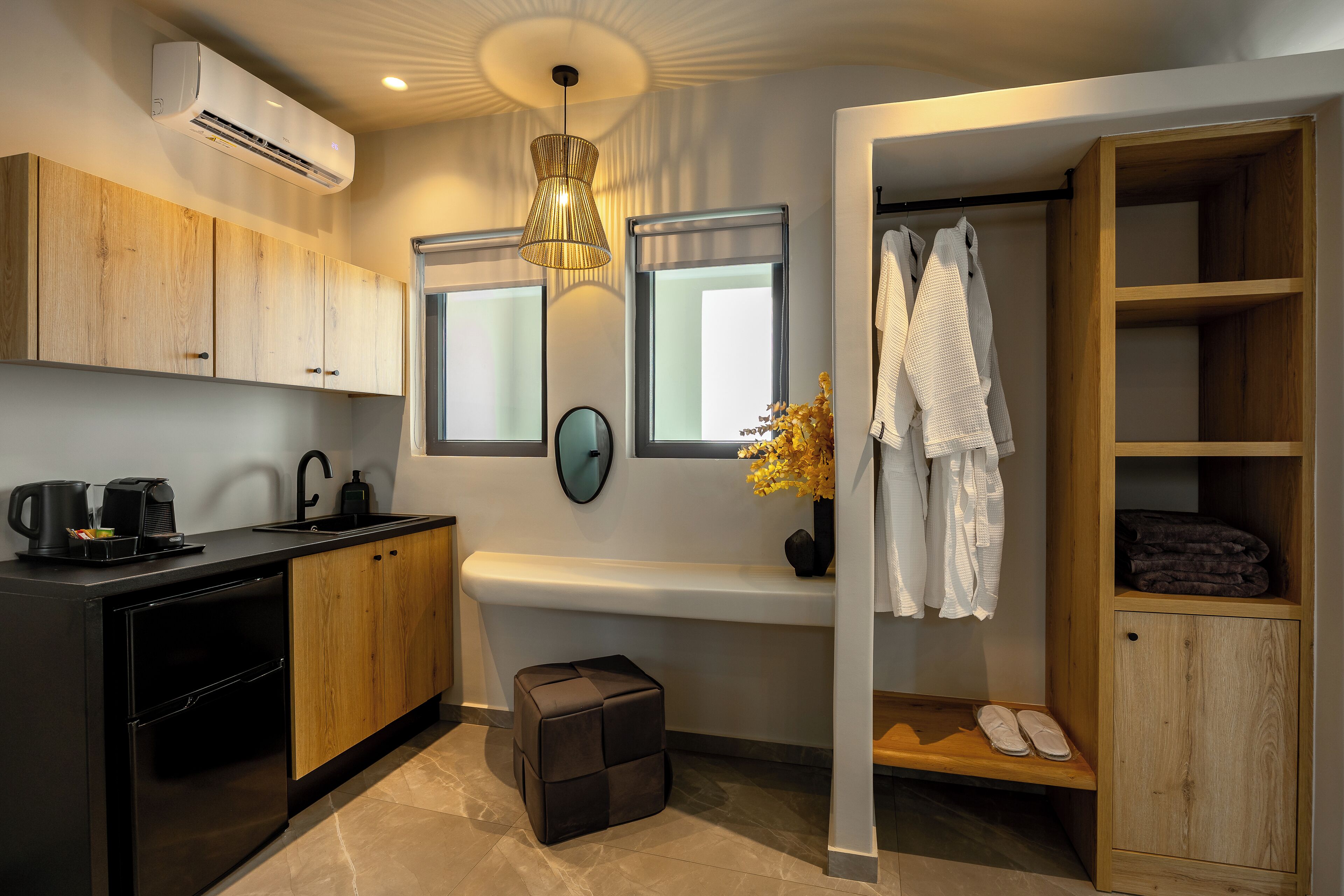 A modern kitchen with a built-in oven, a coffee machine, and a sink.
