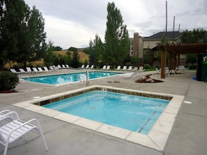 A swimming pool area with two pools, lounge chairs, and a pergola. - 3 BR 3.5bth with 2 En-Suite King Bedrooms (Eden)