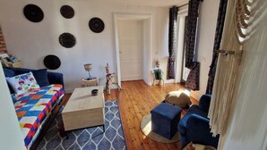 Un salon confortable avec un canapé, une table basse et un fauteuil bleu.