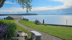 A lakeside view with a gazebo, a stone bench, and a small building. - ZaLo House Waterline cabin with Hot Tub Pets (Peru)