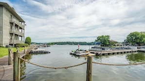 A waterfront hotel with a dock, a wooden walkway, and a view of the water. - Waterfront Condo Retreat in Garland County (Garland County)