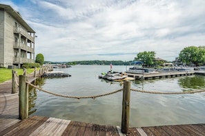 A waterfront hotel with a dock, a wooden walkway, and a view of the water.