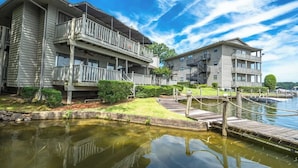 A waterfront hotel with a dock, balconies, and a reflection pool. - Waterfront Condo Retreat in Garland County (Garland County)