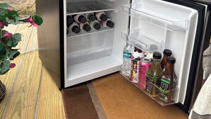 A compact refrigerator with a Hisense brand microwave on top, containing beverages and condiments. - Dome in Wildlife

 (Martville)