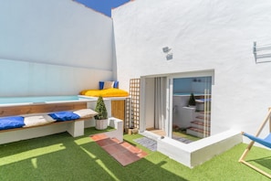 A modern outdoor living area with a pool, a wooden bench, and a glass door leading to a covered patio. - Casa S o Jos in Carvalhal (Bombarral)