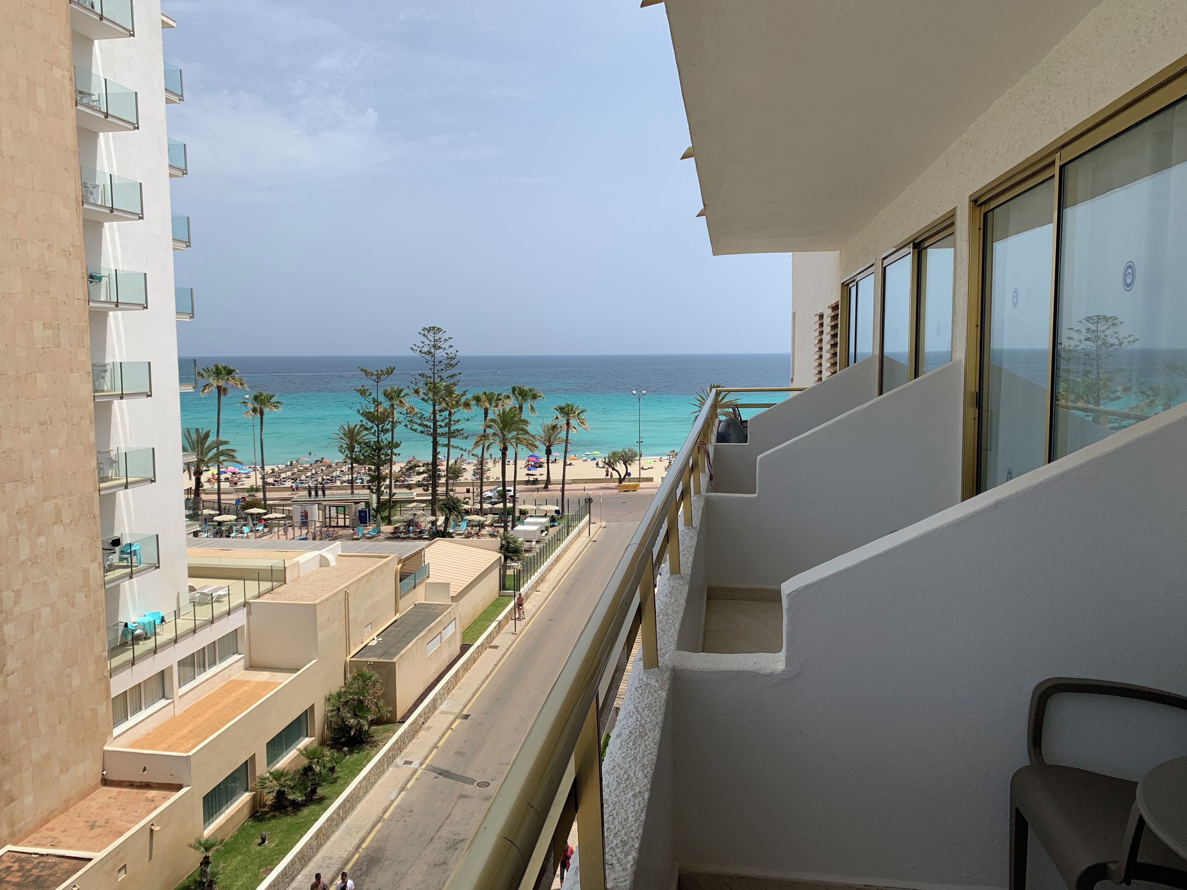 A balcony with a view of a beach and ocean.